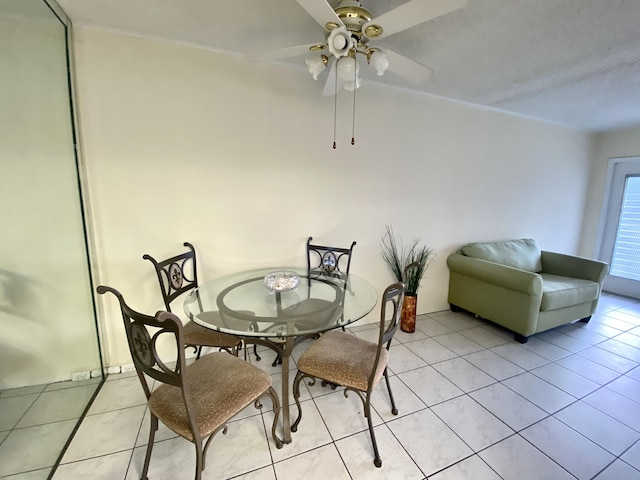 dining space featuring light tile patterned flooring and ceiling fan