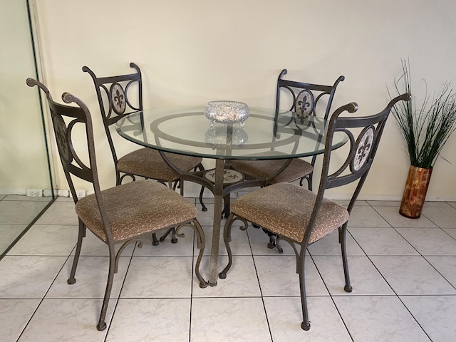 dining room featuring light tile patterned floors and baseboards