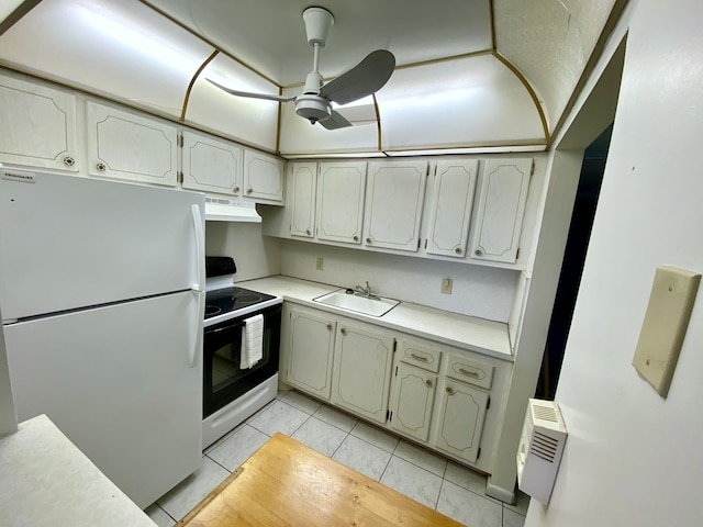 kitchen featuring range with electric cooktop, under cabinet range hood, freestanding refrigerator, marble finish floor, and a sink