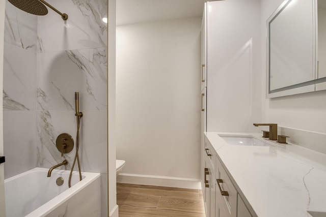 full bath with toilet, tub / shower combination, vanity, wood finished floors, and baseboards