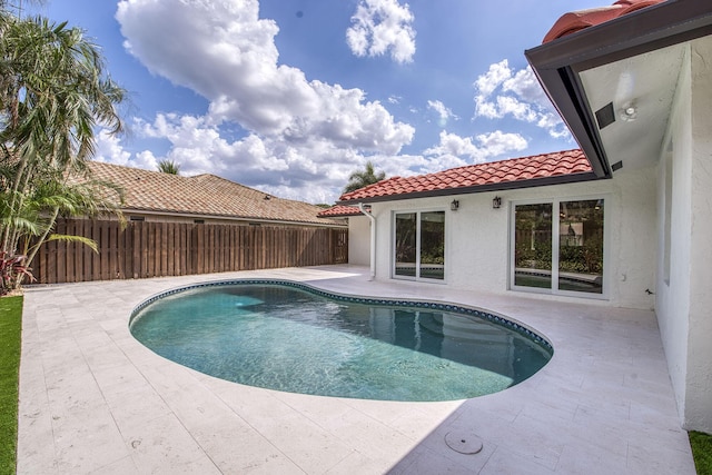 view of pool with a patio, fence, and a fenced in pool