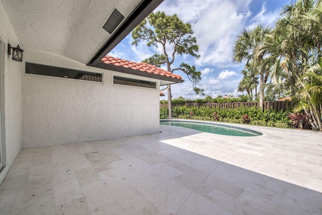 view of pool with a fenced in pool, fence private yard, and a patio