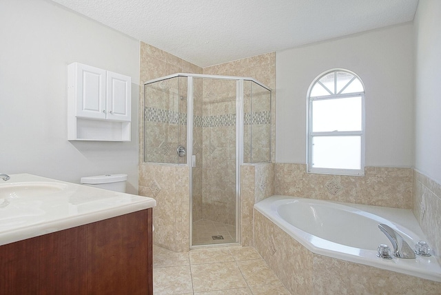 full bathroom with a stall shower, tile patterned flooring, a garden tub, and a textured ceiling