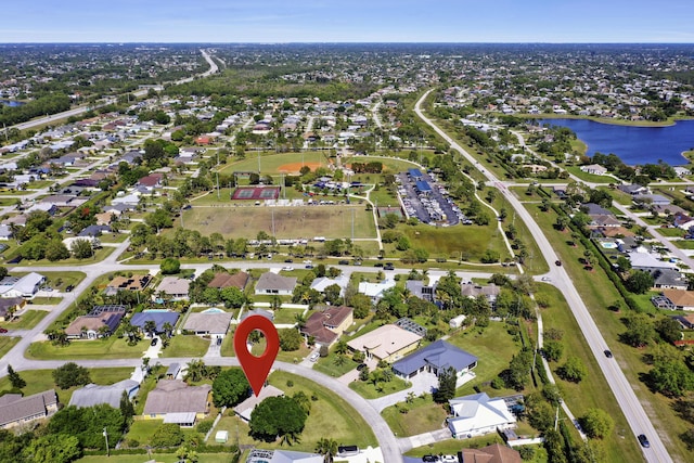 birds eye view of property with a water view and a residential view