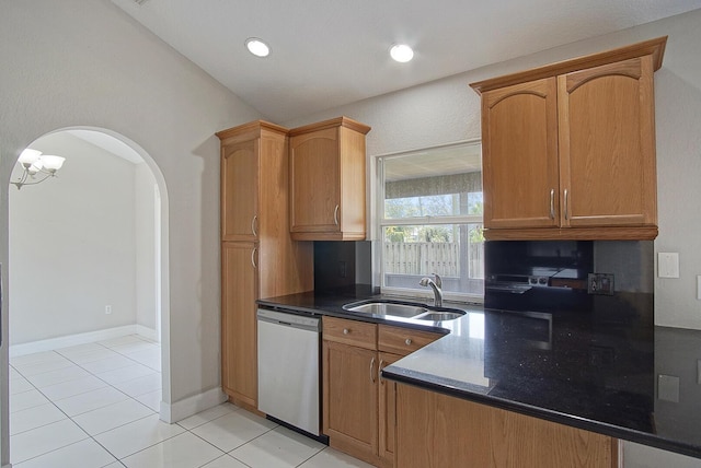 kitchen with arched walkways, light tile patterned floors, recessed lighting, a sink, and dishwasher