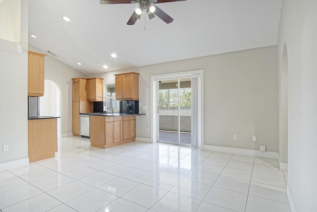 kitchen featuring arched walkways, dishwasher, and light tile patterned floors