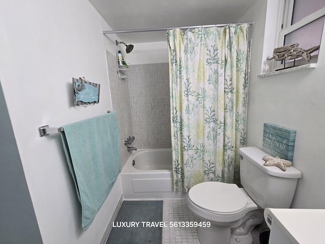 bathroom with tile patterned floors, shower / bath combo with shower curtain, toilet, and vanity