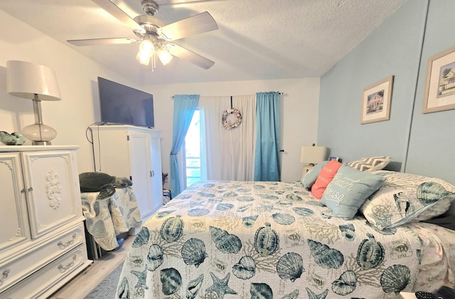 bedroom featuring a ceiling fan, wood finished floors, and a textured ceiling