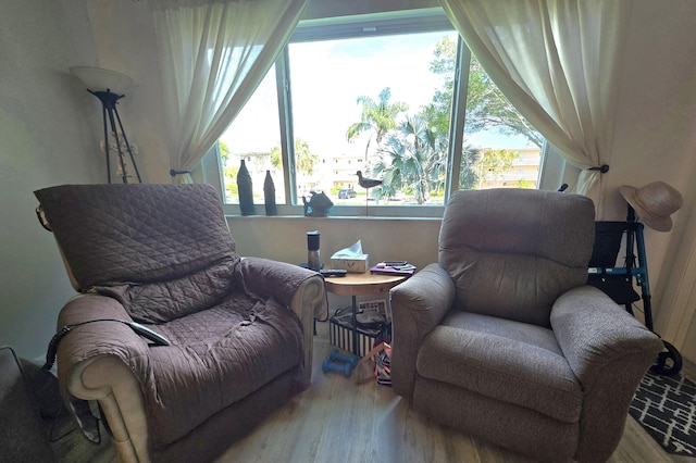 sitting room with a healthy amount of sunlight and wood finished floors