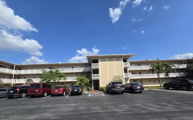 view of building exterior with uncovered parking