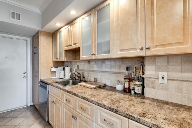 kitchen with a sink, visible vents, ornamental molding, decorative backsplash, and dishwasher