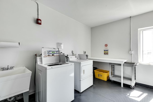 laundry area with a sink and washing machine and clothes dryer