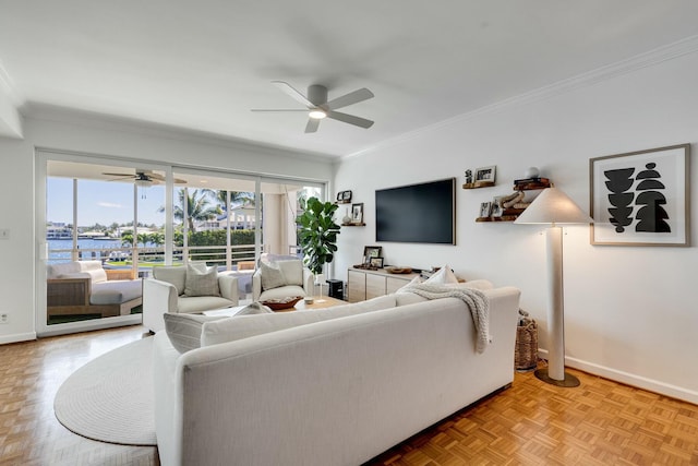 living room with ceiling fan, ornamental molding, and baseboards