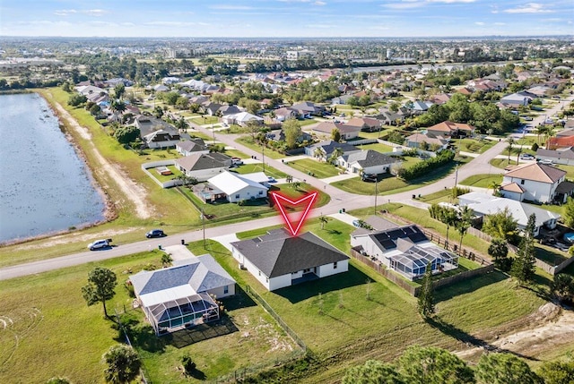 birds eye view of property with a water view and a residential view