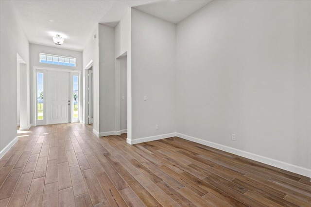 entryway with baseboards and wood finished floors