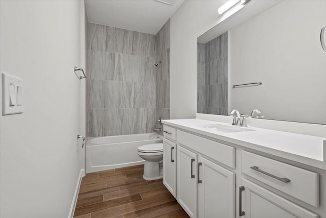 full bath with shower / bath combination, vanity, toilet, and wood finished floors