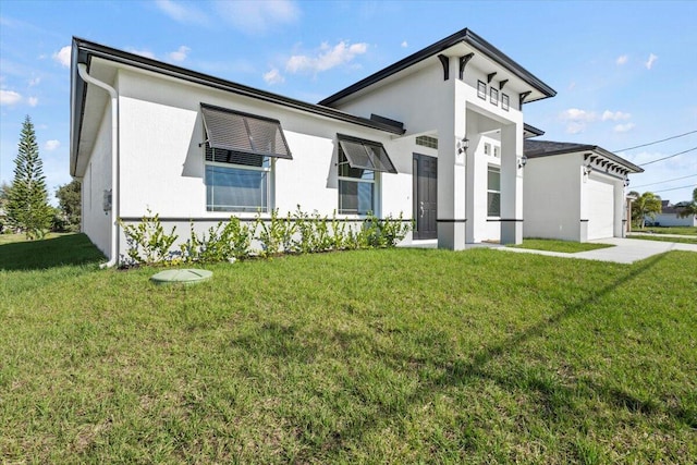 view of front of property with an attached garage, stucco siding, concrete driveway, and a front yard