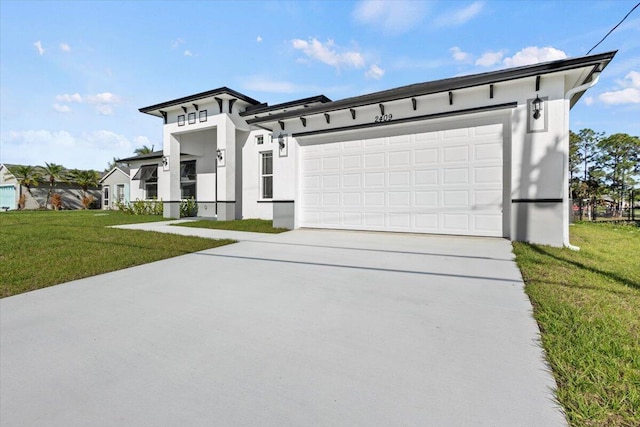 view of front of home with a front lawn, concrete driveway, an attached garage, and stucco siding