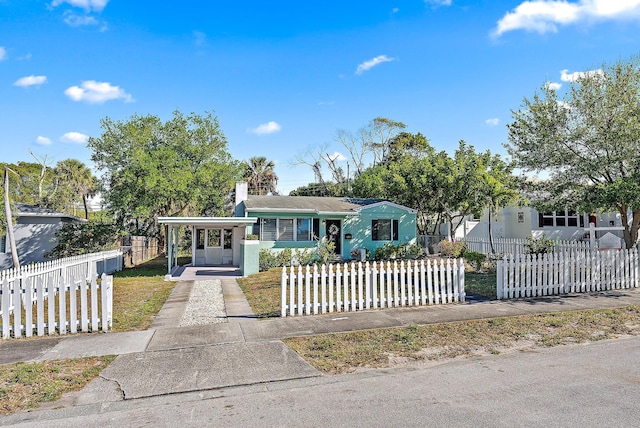 view of front of house with a fenced front yard and a chimney