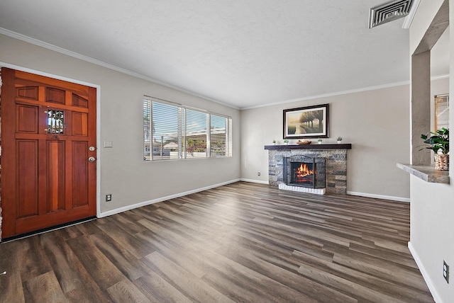 unfurnished living room featuring visible vents, a fireplace, crown molding, baseboards, and dark wood-style flooring