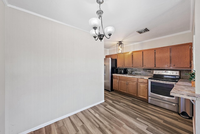 kitchen with visible vents, backsplash, light countertops, ornamental molding, and appliances with stainless steel finishes