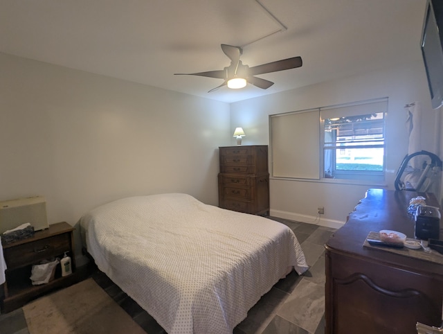 bedroom featuring baseboards and ceiling fan