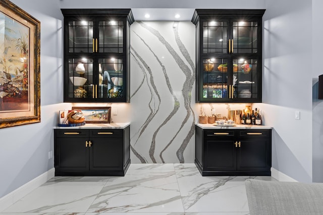 bar featuring recessed lighting, marble finish floor, and a bar