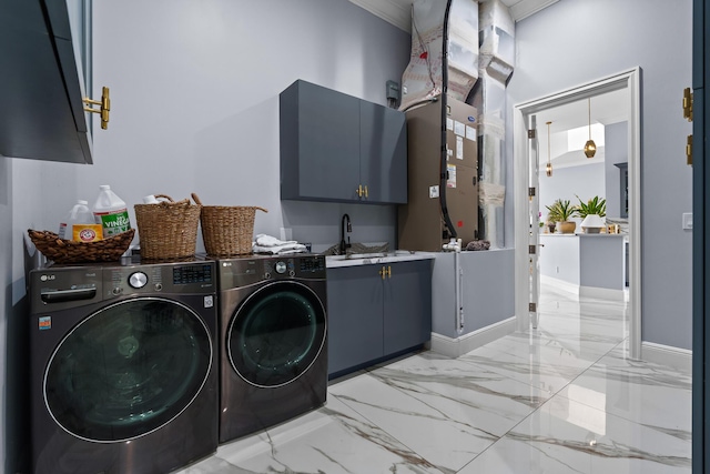 laundry area with baseboards, separate washer and dryer, cabinet space, a sink, and marble finish floor