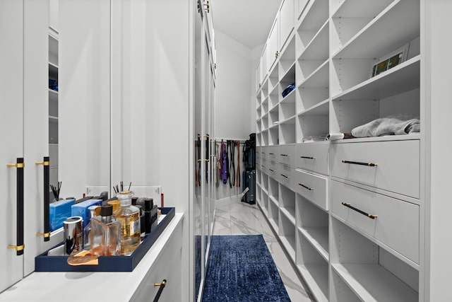 walk in closet with marble finish floor