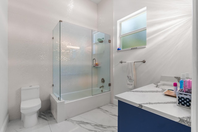 bathroom with vanity, toilet, marble finish floor, and bath / shower combo with glass door