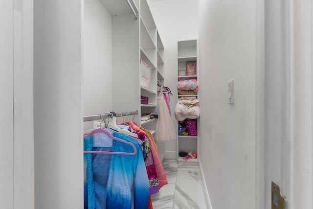 spacious closet with marble finish floor