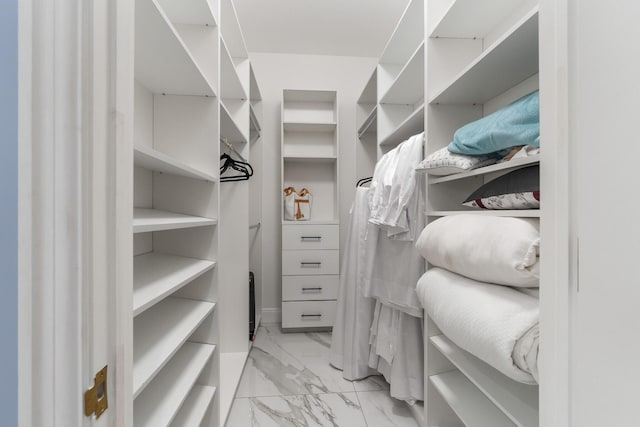 spacious closet with marble finish floor