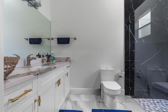 bathroom featuring vanity, baseboards, tiled shower, toilet, and marble finish floor