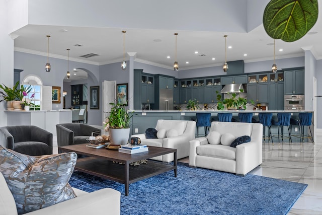 living area featuring visible vents, marble finish floor, ornamental molding, recessed lighting, and arched walkways