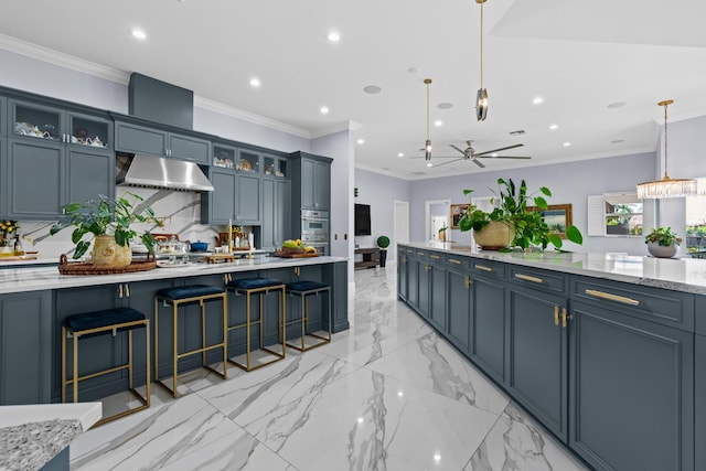 kitchen with recessed lighting, ornamental molding, decorative backsplash, hanging light fixtures, and under cabinet range hood