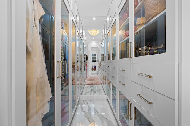 walk in closet with marble finish floor