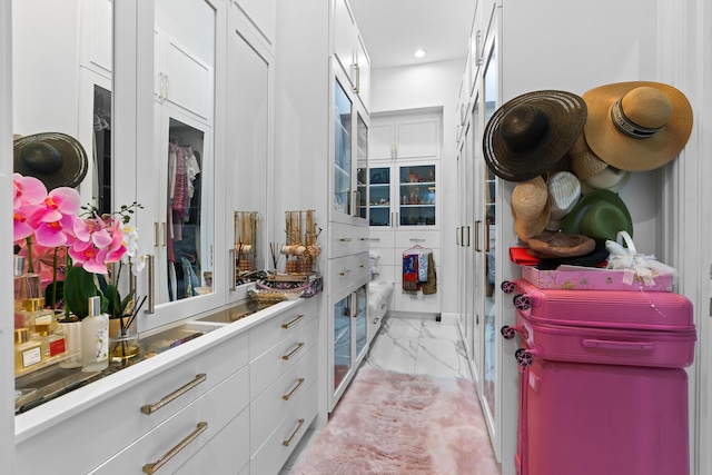 spacious closet featuring marble finish floor