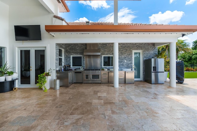 view of patio featuring french doors, exterior kitchen, and a sink