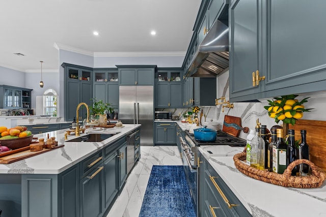 kitchen featuring a sink, decorative backsplash, marble finish floor, under cabinet range hood, and premium appliances