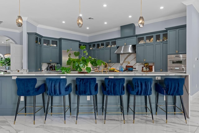 kitchen with under cabinet range hood, visible vents, tasteful backsplash, and light countertops