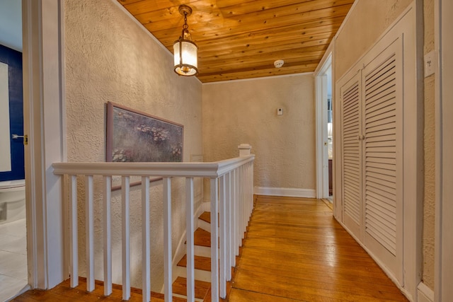 270 Cordova Rd, West Palm Beach, FL 33401 - corridor featuring wood ceiling, a textured wall, hardwood / wood-style floors, and baseboards