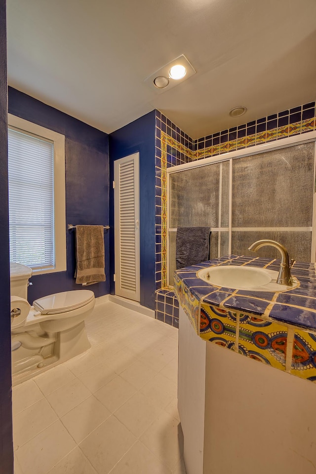 270 Cordova Rd, West Palm Beach, FL 33401 - full bathroom featuring vanity, toilet, tile patterned flooring, and a stall shower