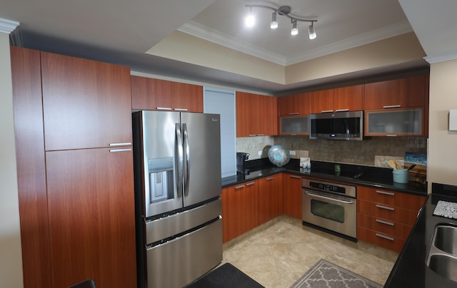 kitchen featuring dark countertops, tasteful backsplash, ornamental molding, appliances with stainless steel finishes, and brown cabinetry