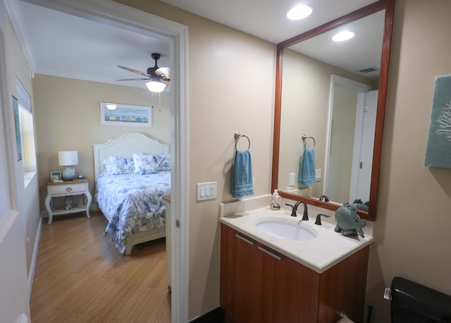 bathroom with visible vents, a ceiling fan, wood finished floors, recessed lighting, and vanity