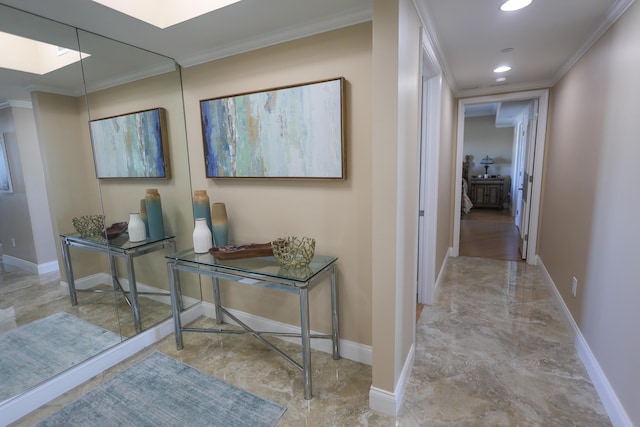 corridor with a skylight, baseboards, and ornamental molding