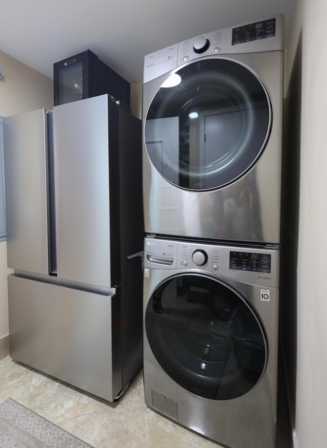 laundry area with stacked washer and clothes dryer and laundry area