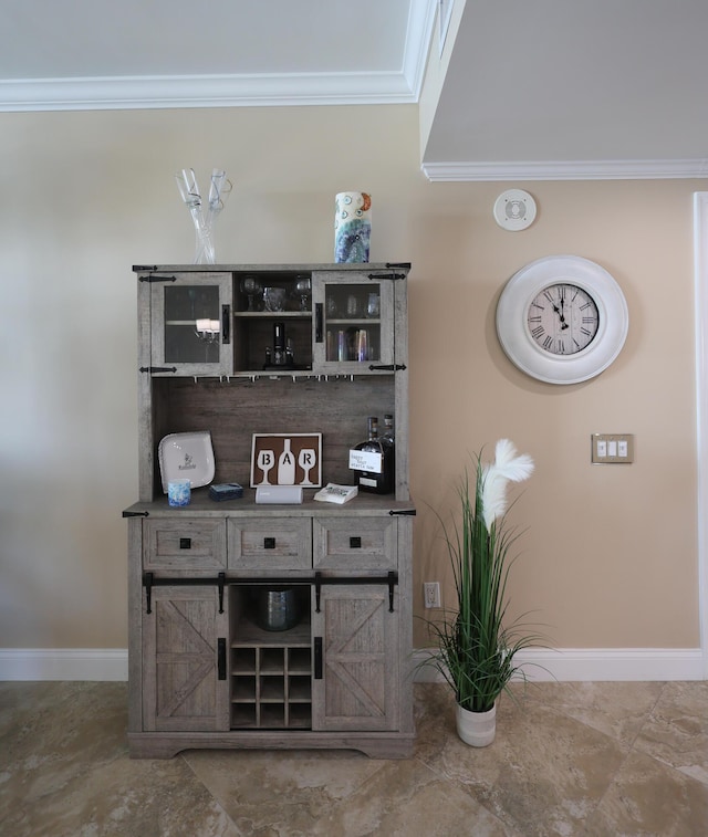 bar featuring crown molding and baseboards