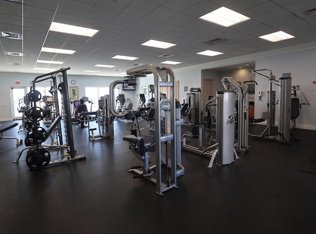 workout area with visible vents, baseboards, and a drop ceiling