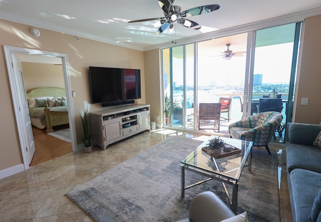 living room featuring crown molding, a ceiling fan, baseboards, and expansive windows