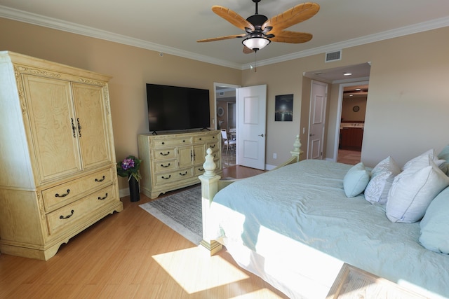 bedroom with visible vents, baseboards, ornamental molding, and light wood finished floors